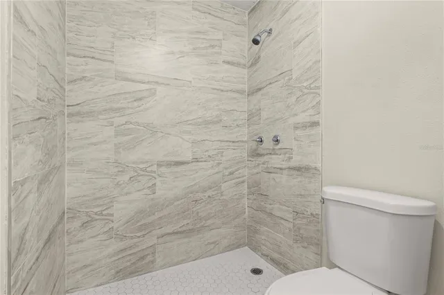 a bathroom with a shower and a toilet