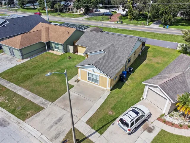 an aerial view of a house with a yard