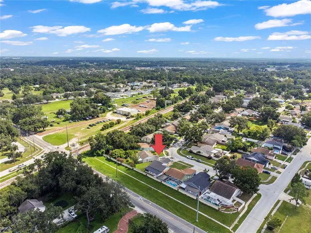 an aerial view of residential houses with outdoor space and swimming pool