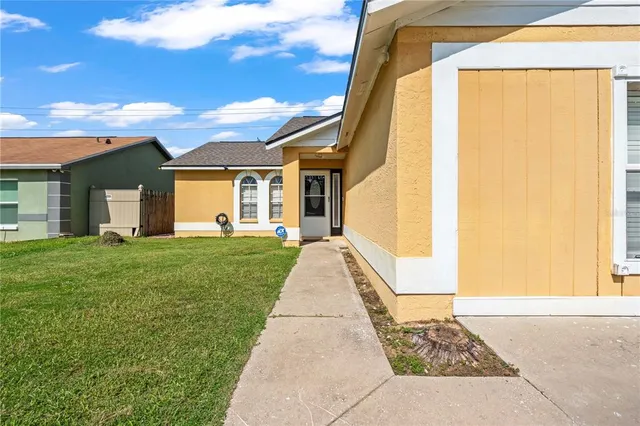 a very nice looking house with a big yard and plants