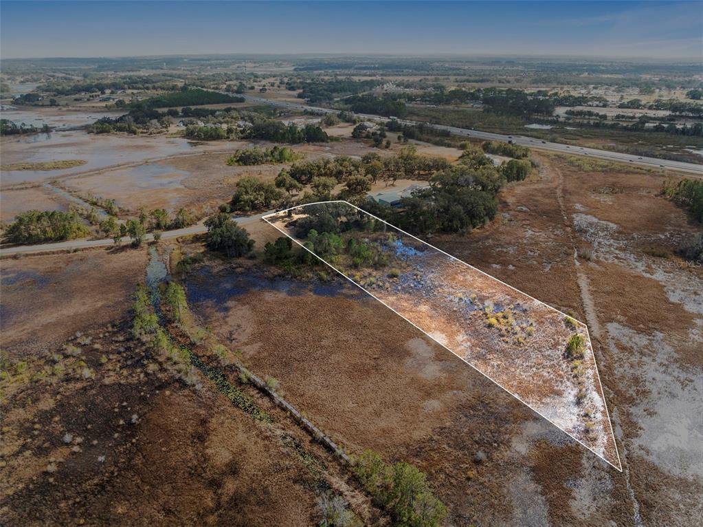 446 Long And Winding Road Howey-in-the-Hills, FL 34737 - Photo 2 of 32 a view of a lake with a city