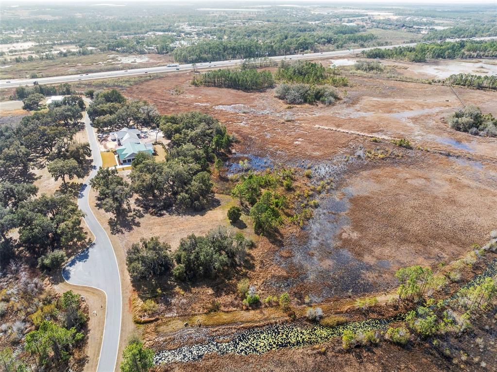 446 Long And Winding Road Howey-in-the-Hills, FL 34737 - Photo 23 of 32 view of a lake with beach and green space