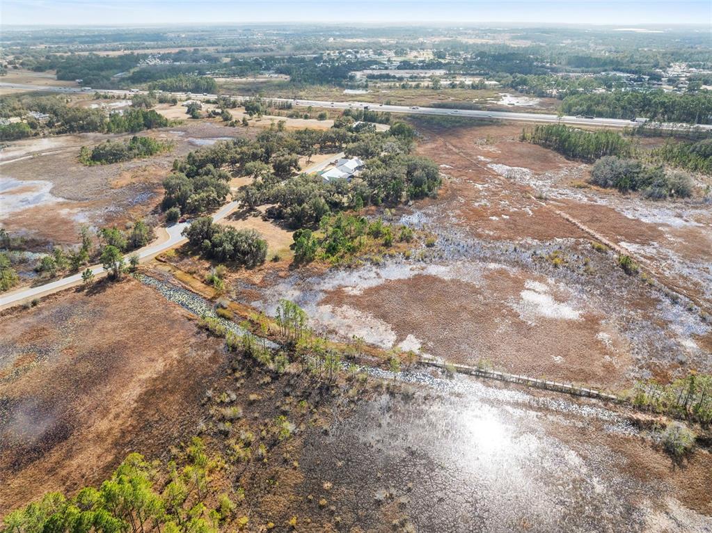446 Long And Winding Road Howey-in-the-Hills, FL 34737 - Photo 25 of 32 an aerial view of residential houses with outdoor space