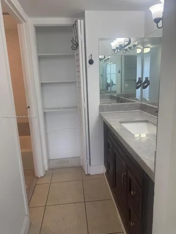 a bathroom with a double vanity sink and mirror