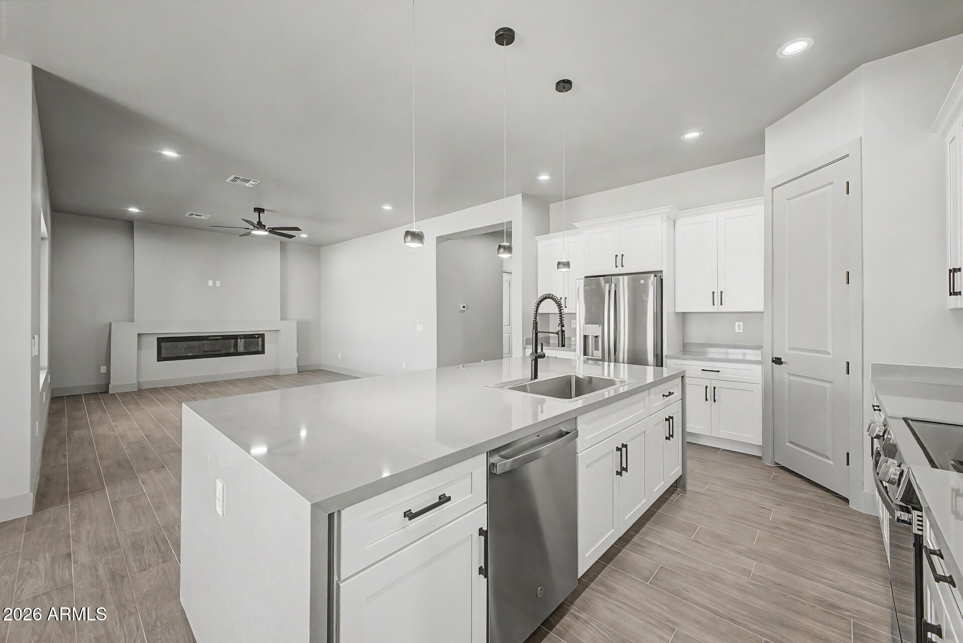 40461 West Robles Road Stanfield, AZ 85172 - Photo 28 of 54 a kitchen with white cabinets and white appliances