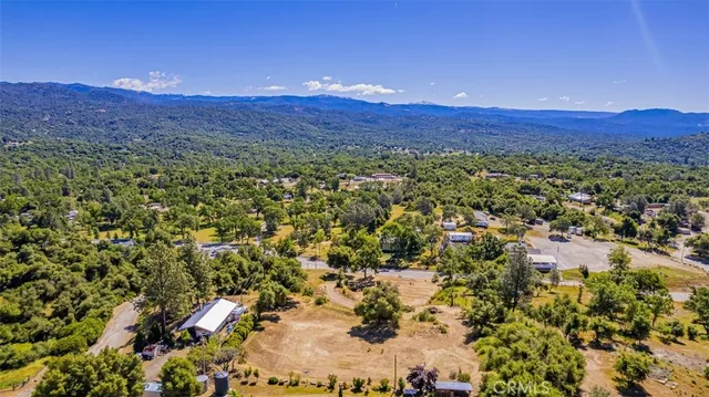 a view of a lush green hillside and houses
