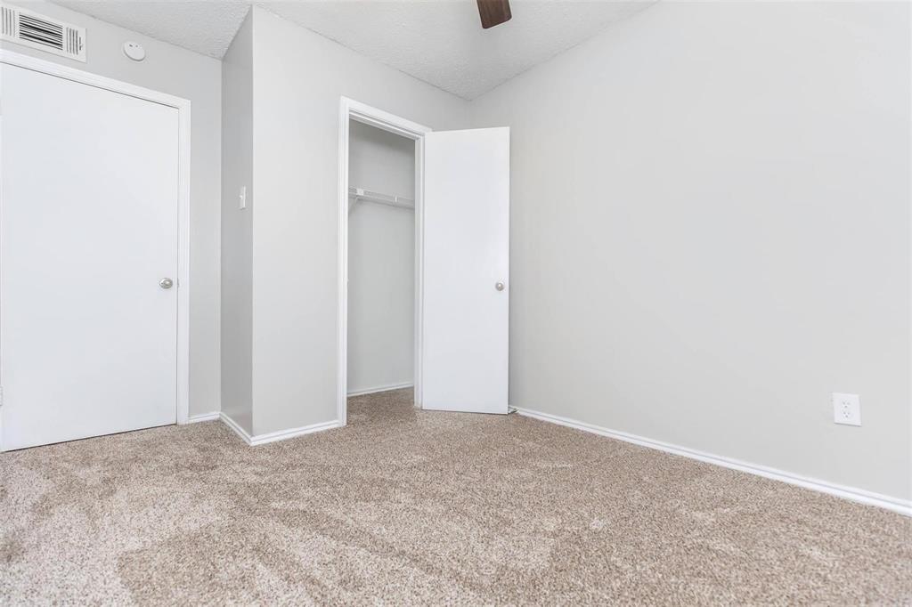 1826 Esters Road, Unit 2009 Irving, TX 75061 - Photo 26 of 39 The property features a room with light-colored carpeted flooring, light grey walls, and white trim