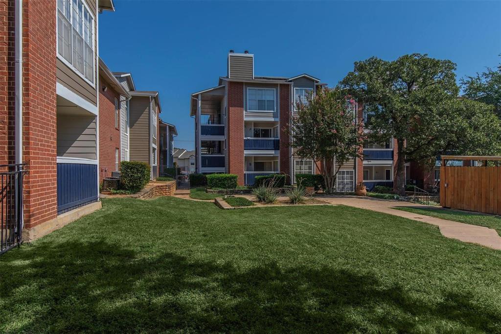 1826 Esters Road, Unit 2009 Irving, TX 75061 - Photo 38 of 39 The property features a well-maintained lawn with mature trees and landscaping