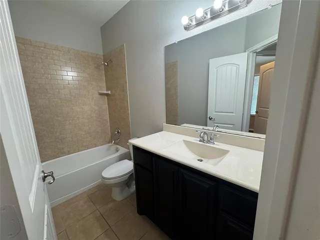 a bathroom with a sink a toilet a mirror and shower