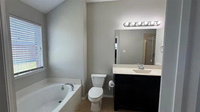 a bathroom with a toilet sink and shower