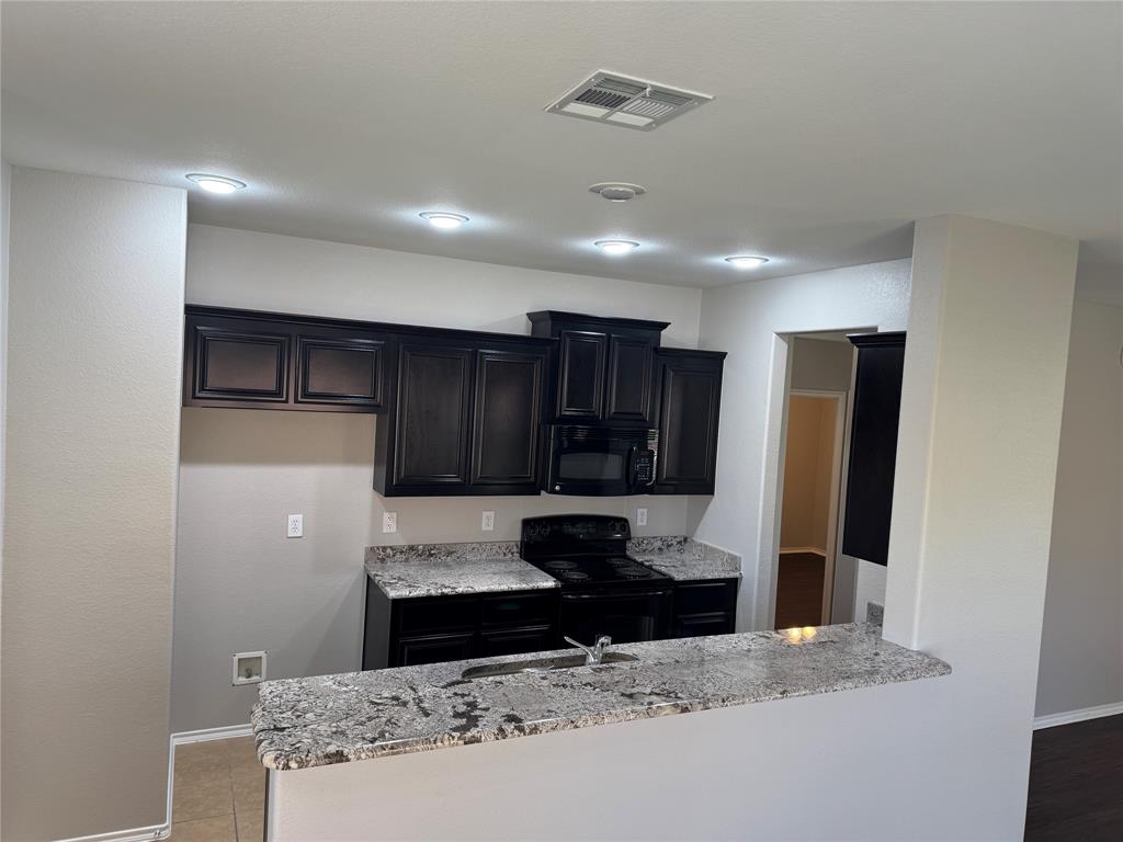 117 Chalk Road Anna, TX 75409 - Photo 4 of 32 a view of a kitchen with a sink and a refrigerator