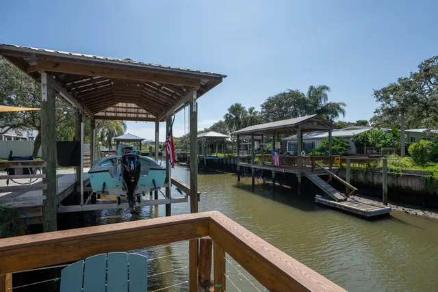 a view of a lake with a wooden deck