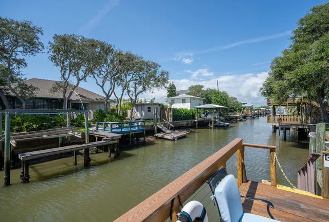 a view of swimming pool with outdoor seating and lake view