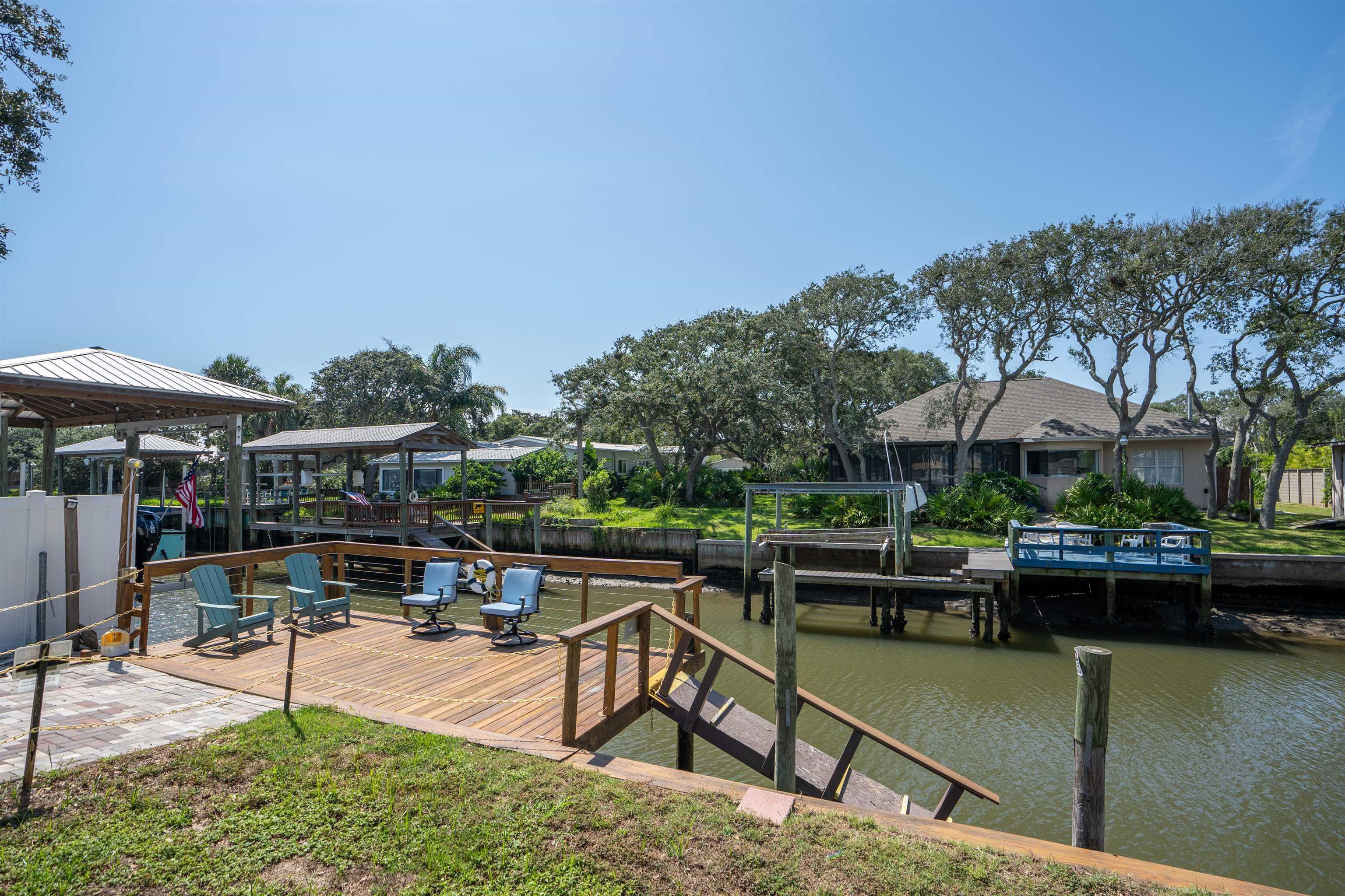 231 Ventura Road St. Augustine, FL 32080 - Photo 18 of 47 a view of a swimming pool with chairs in patio