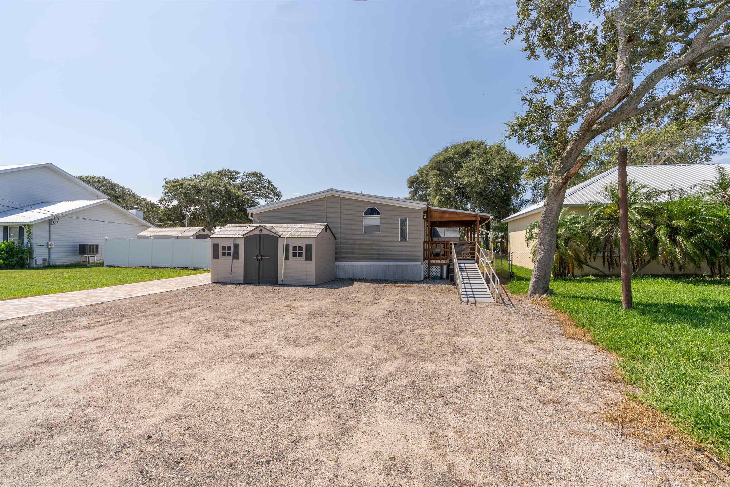 231 Ventura Road St. Augustine, FL 32080 - Photo 2 of 47 a front view of a house with a yard and garage