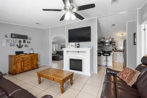 a living room with furniture a flat screen tv and a fireplace