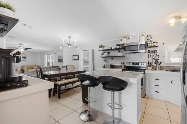 a kitchen with cabinets and chairs