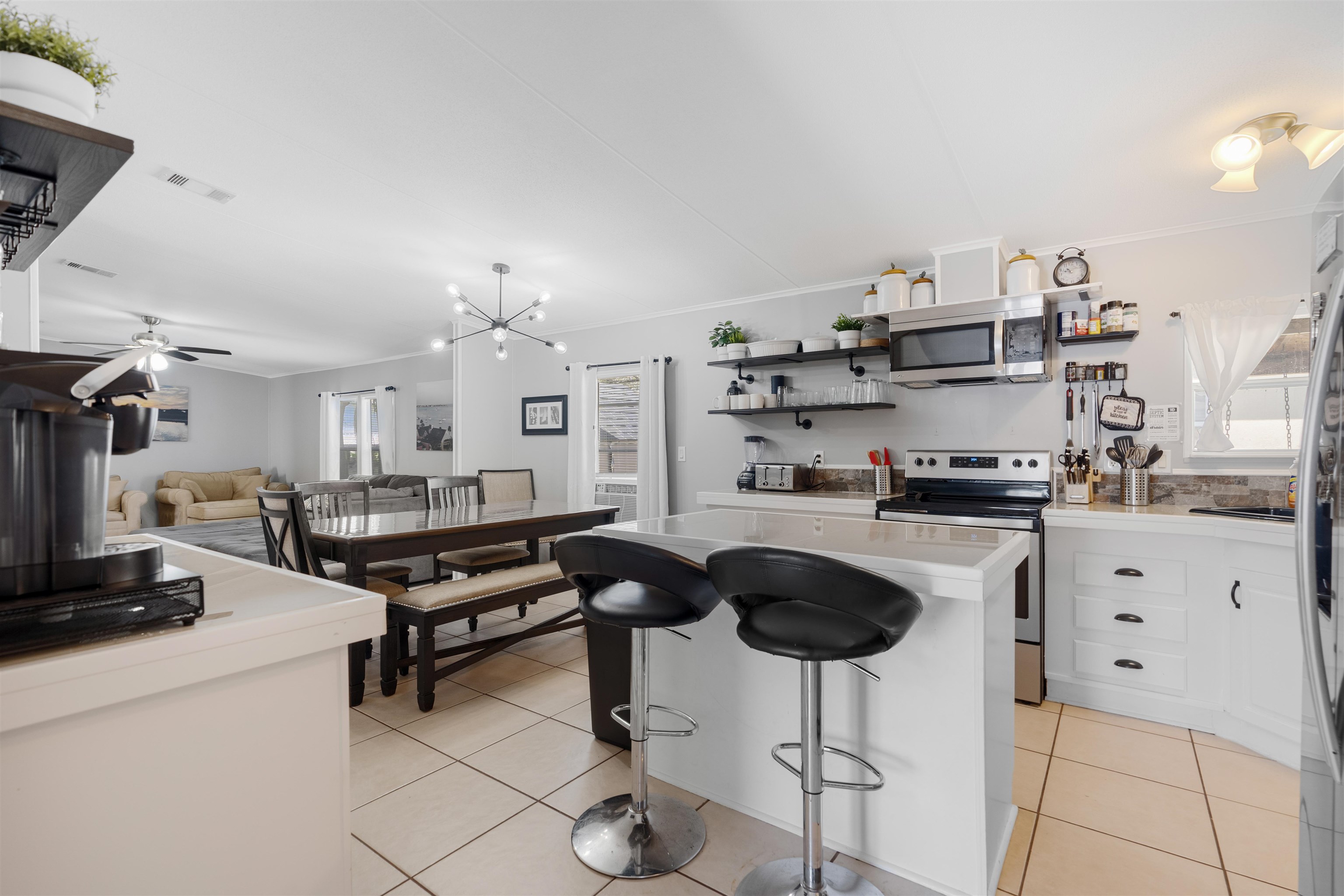 231 Ventura Road St. Augustine, FL 32080 - Photo 24 of 47 a kitchen with cabinets and chairs