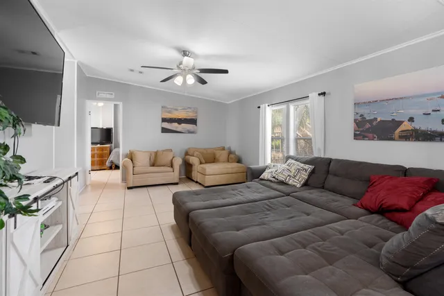 a spacious bedroom with a bed couch and window