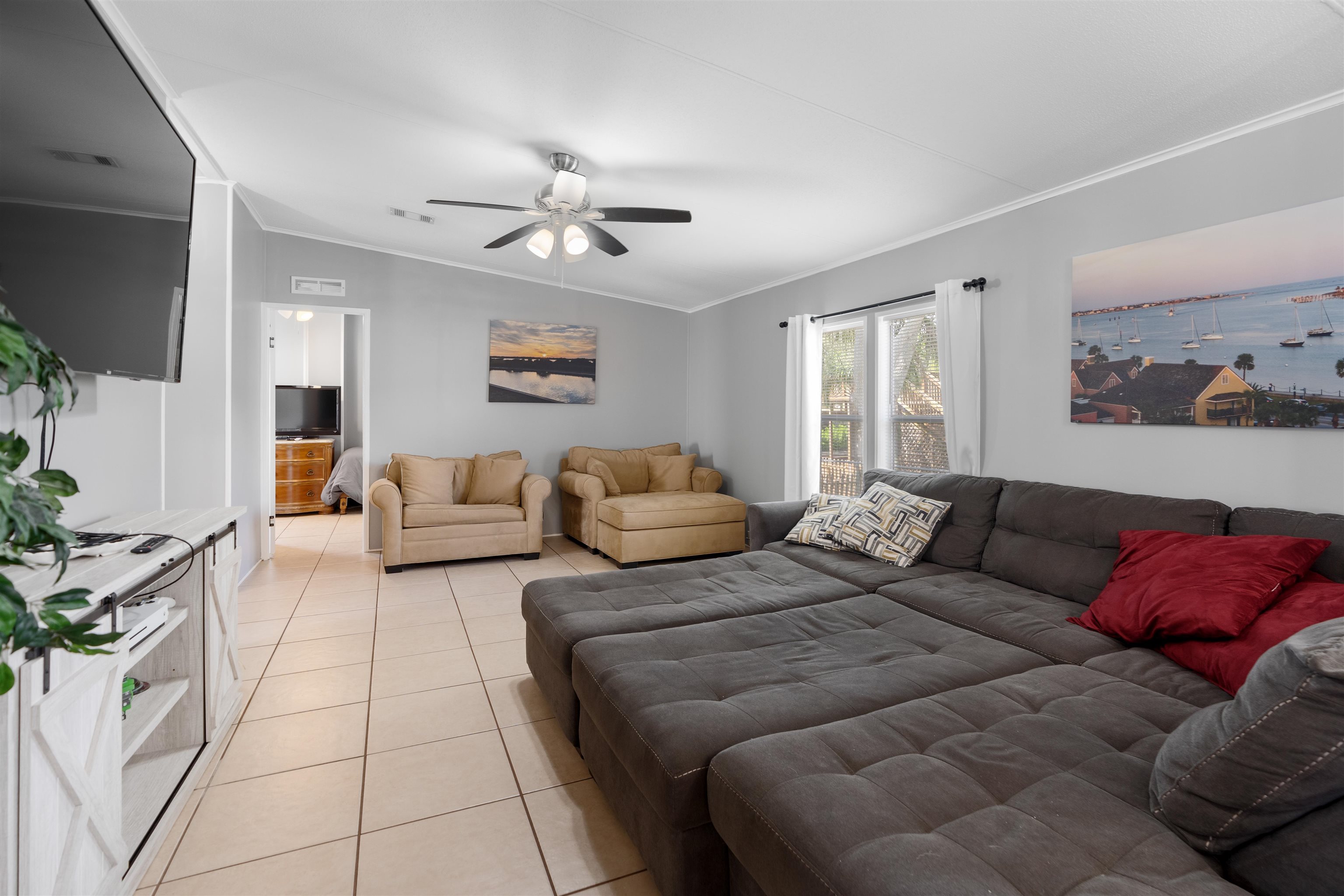 231 Ventura Road St. Augustine, FL 32080 - Photo 27 of 47 a spacious bedroom with a bed couch and window