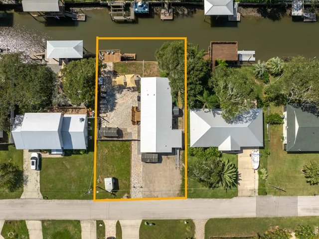 an aerial view of a house with a swimming pool