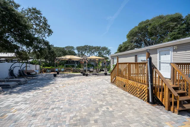a view of a house with backyard and sitting area