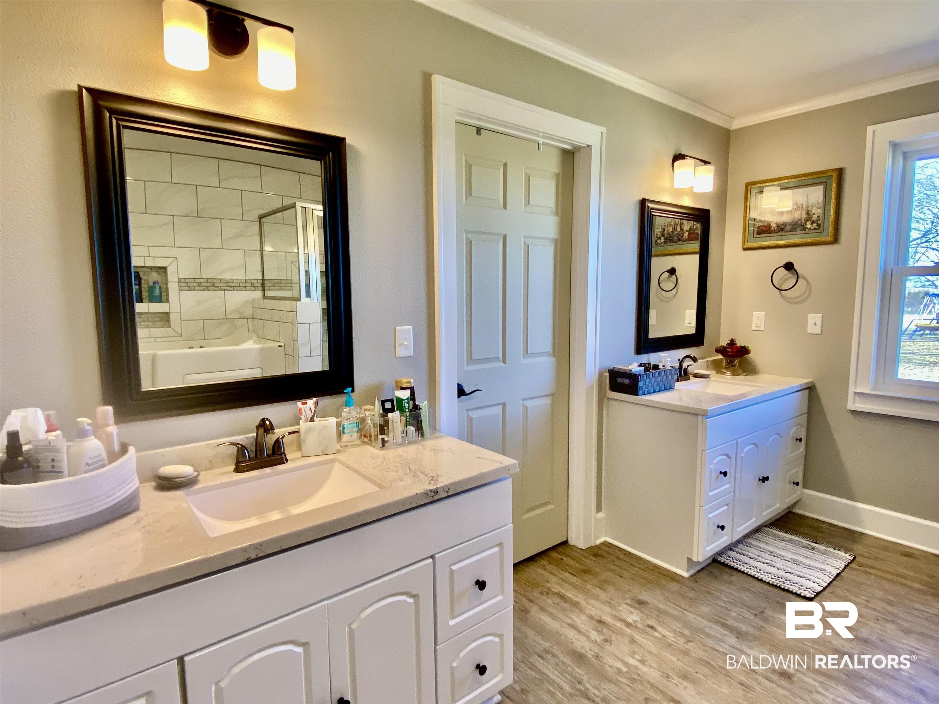 2711 County Road 5 Repton, AL 36475 - Photo 22 of 36 Bathroom with hardwood / wood-style floors, a shower with door, crown molding, and vanity