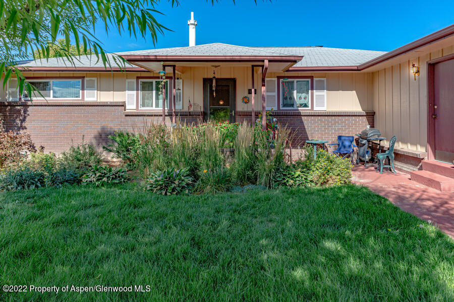 341 Clarkson Avenue Rifle, CO 81650 - Photo 1 of 16 a front view of a house with a yard