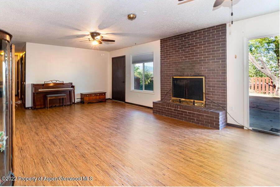 341 Clarkson Avenue Rifle, CO 81650 - Photo 12 of 16 a living room with furniture and a fireplace