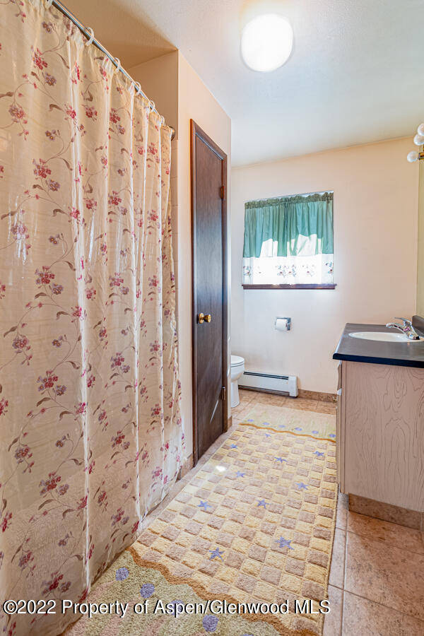 341 Clarkson Avenue Rifle, CO 81650 - Photo 10 of 16 a view of a bathroom with a sink and a mirror