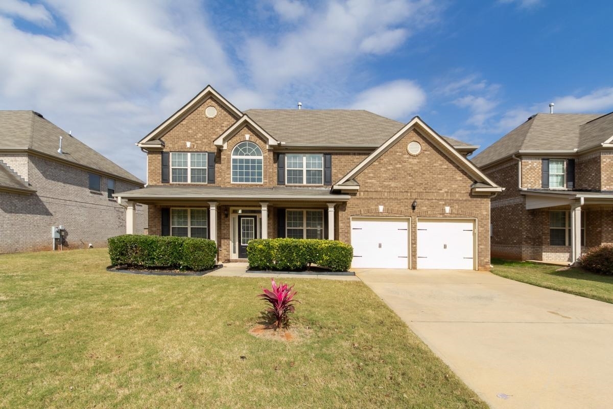 a front view of a house with a yard