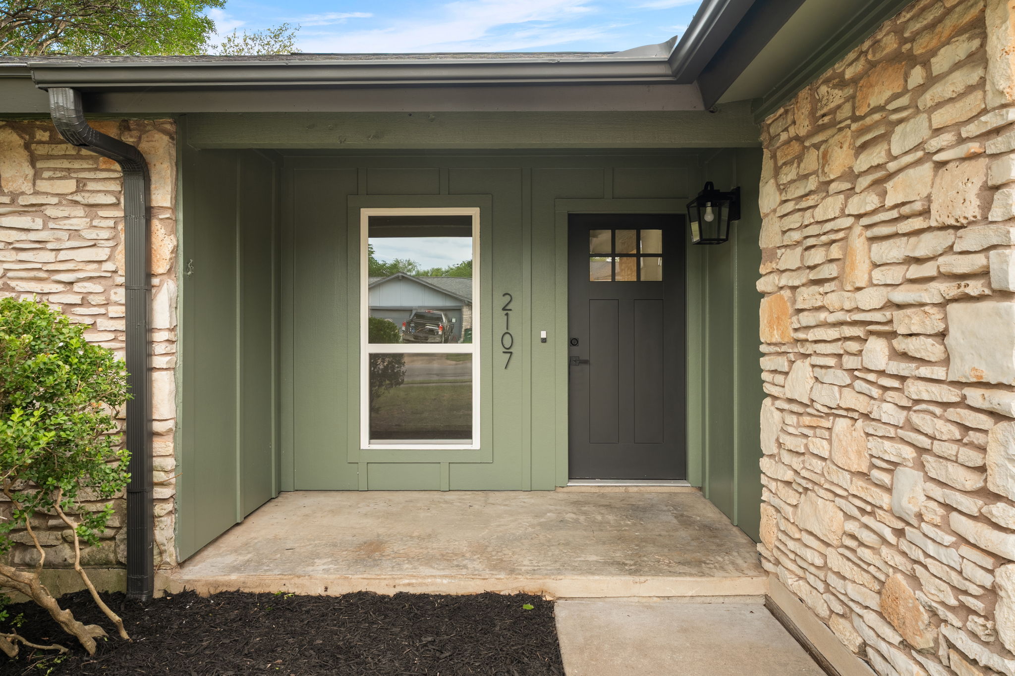 2107 Cindy Lane Austin, TX 78727 - Photo 4 of 33 Stone veneer exterior with green siding accents