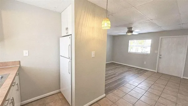 an empty room with windows and mirror
