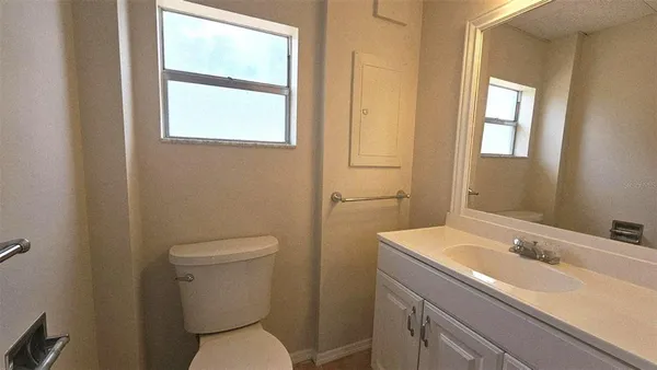 a bathroom with a toilet sink and mirror
