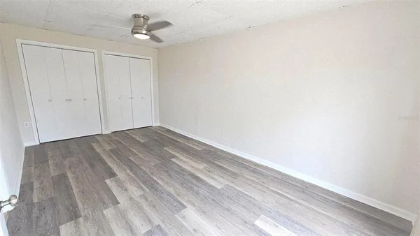 a view of room with wooden floor