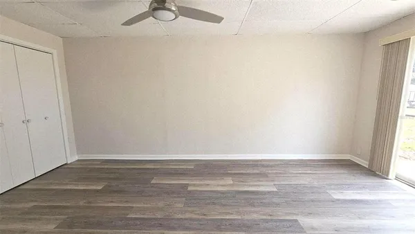a view of a room with wooden floor and white walls