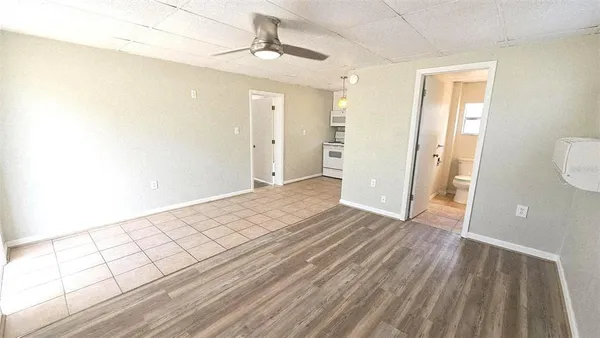 a view of an empty room with wooden floor