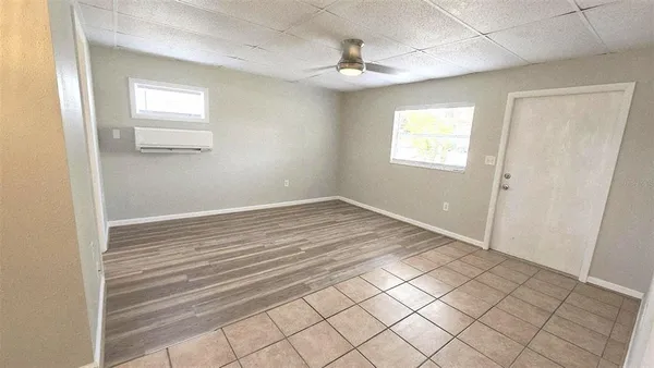 a view of a livingroom with wooden floor and window