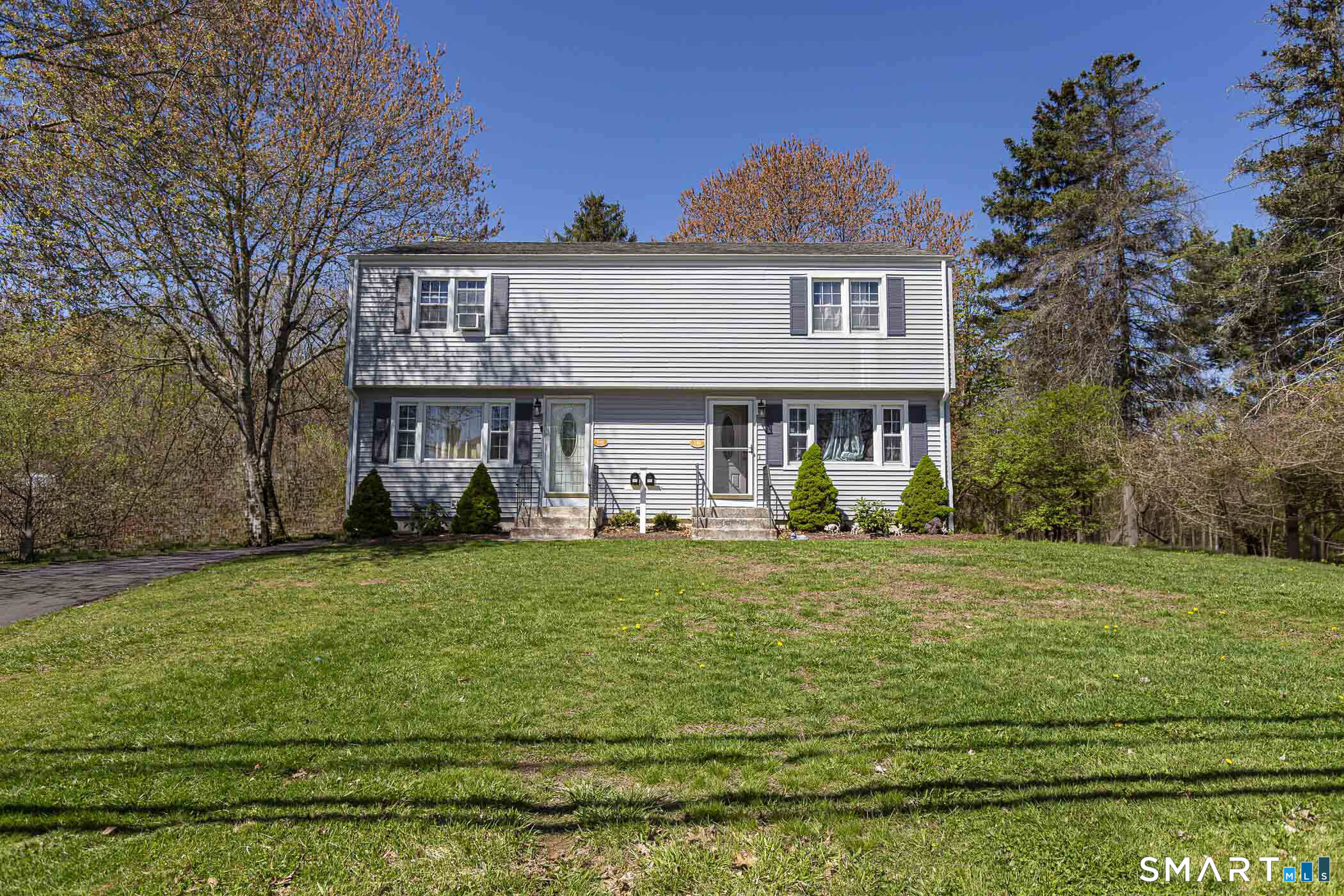 a front view of a house with a garden