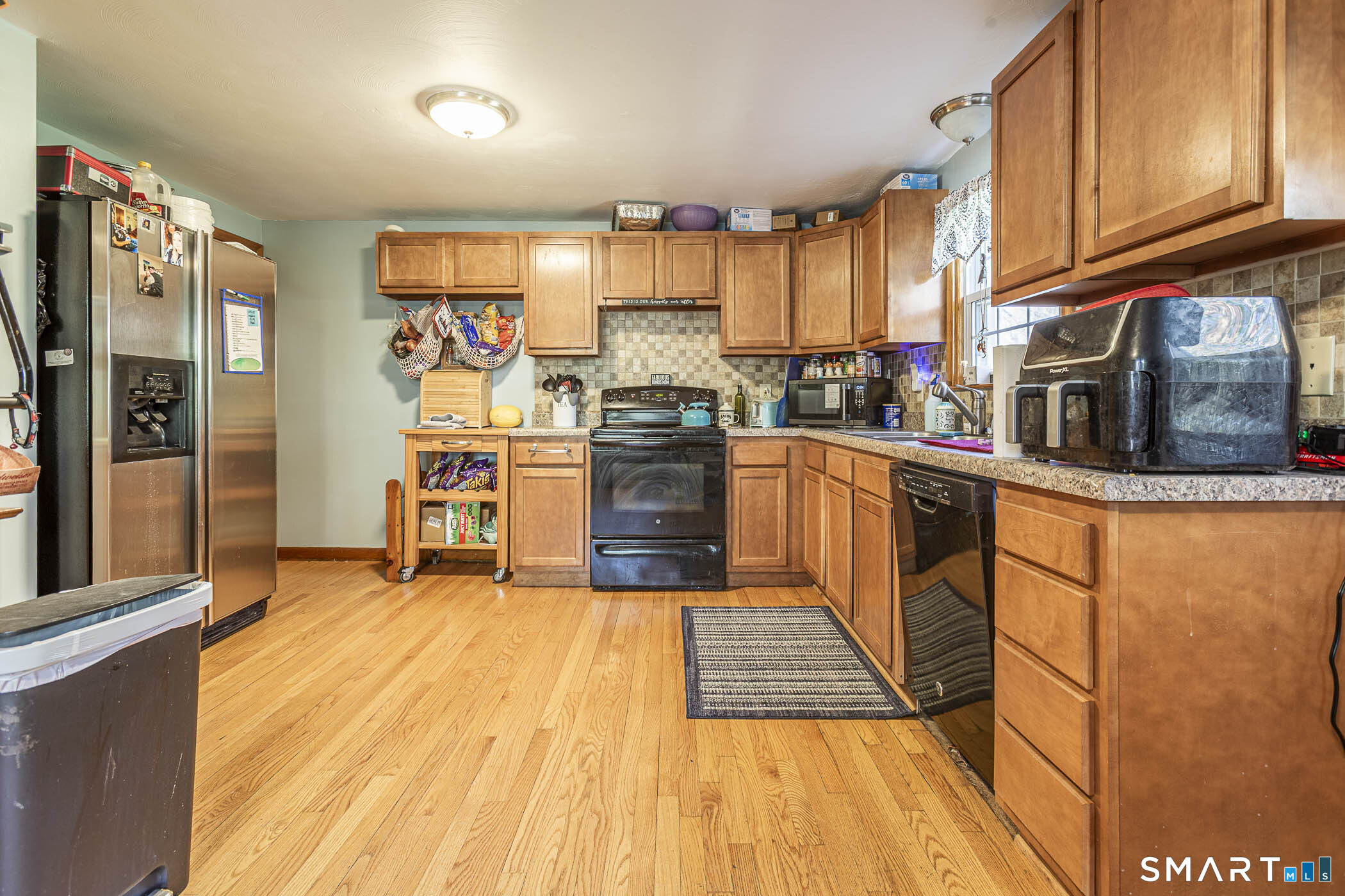 146 Union Street Manchester, CT 06042 - Photo 11 of 27 a kitchen with stainless steel appliances granite countertop a refrigerator a stove top oven and a sink with large cabinets
