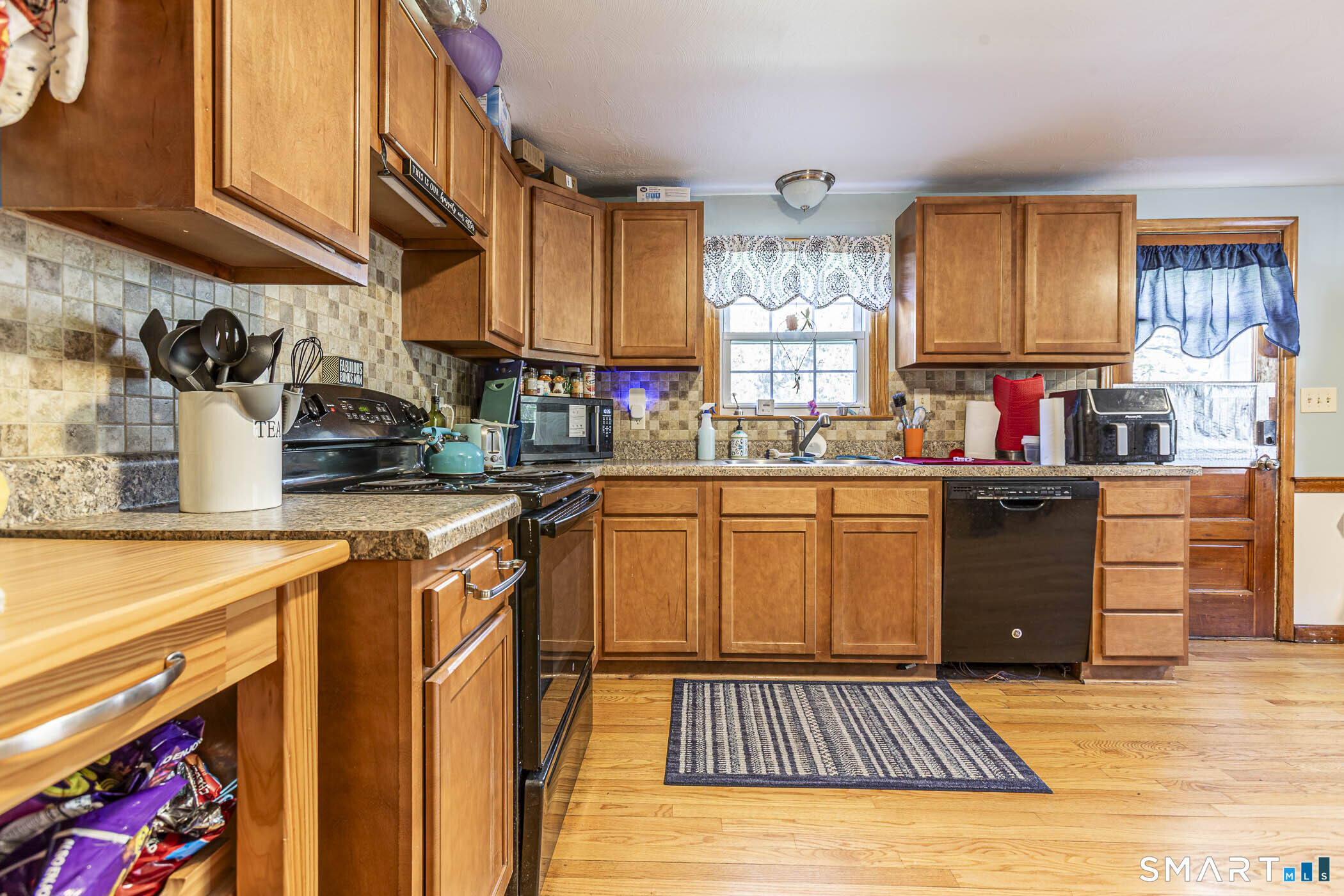 146 Union Street Manchester, CT 06042 - Photo 12 of 27 a kitchen with stainless steel appliances granite countertop a stove a sink dishwasher and cabinets with wooden floor