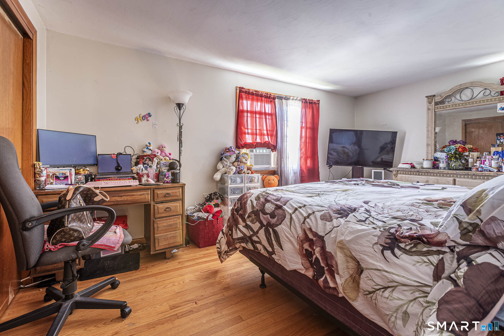 146 Union Street Manchester, CT 06042 - Photo 26 of 27 a bedroom with a bed and wooden floor