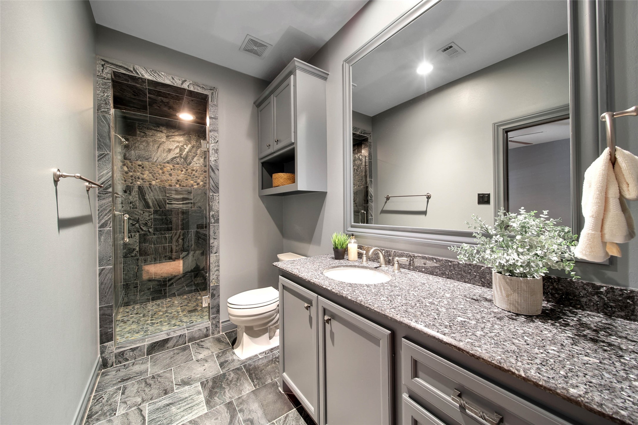 852 Eagle Pointe Montgomery, TX 77316 - Photo 36 of 48 a bathroom with a granite countertop sink a toilet and shower