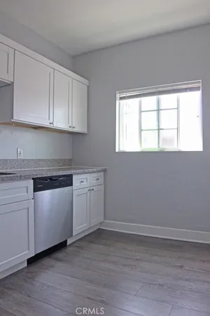 a kitchen with stainless steel appliances granite countertop a stove microwave and sink