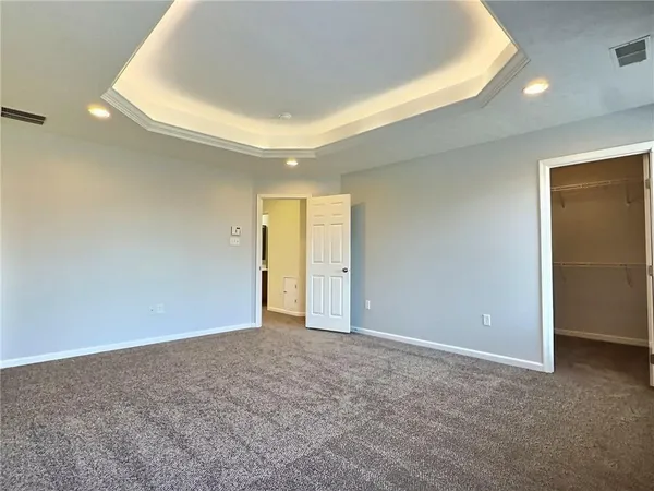 a spacious bathroom with a tub shower and mirror