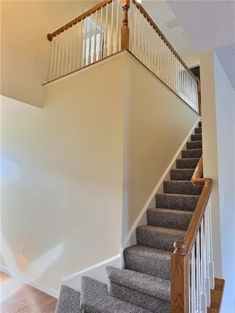 a view of an empty room with window and fire place