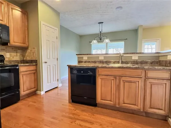 a kitchen with a refrigerator a sink and a cabinets