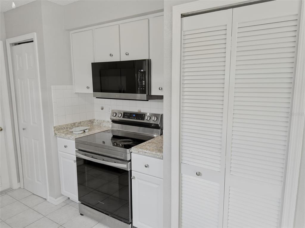 2202 Godfrey Avenue Spring Hill, FL 34609 - Photo 14 of 36 a kitchen with a stove and a microwave
