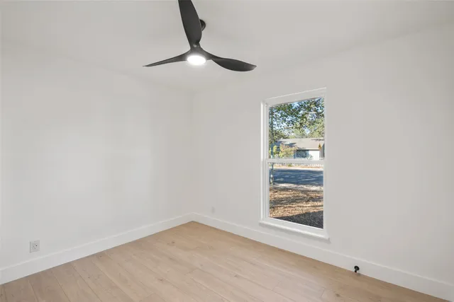 a view of room with window and ceiling fan