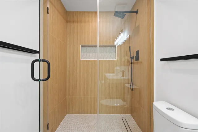 a bathroom with a shower and toilet